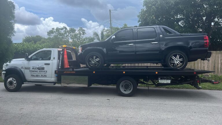 Alexpress Towing flatbed truck carrying a pickup in Broward County, Florida