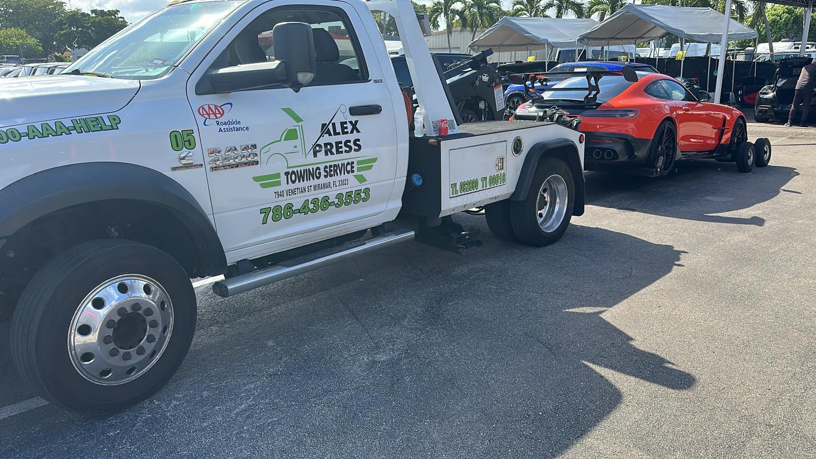 Alexpress tow truck recovering a vehicle in Broward County